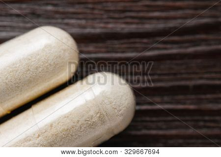 White Medical Capsules Of Glucosamine Chondroitin, Healthy Supplement Pills On Wooden Background, Ma