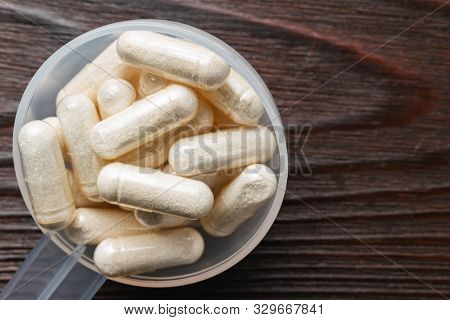 White Medical Capsules Of Glucosamine Chondroitin, Healthy Supplement Pills In The Plastic Spoon On 