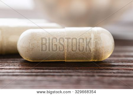 White Medical Capsules Of Glucosamine Chondroitin, Healthy Supplement Pills On Wooden Background, Ma