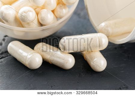 White Medical Capsules Of Glucosamine Chondroitin, Healthy Supplement Pills On Dark Background, Macr