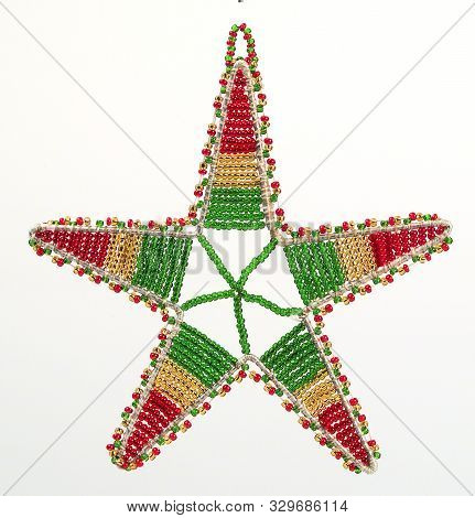 A Closeup Picture Of A Beaded Wire Star Christmas Tree Decorations In Red Green And Gold