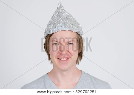 Face Of Happy Young Man With Tinfoil Hat As Conspiracy Theory Concept