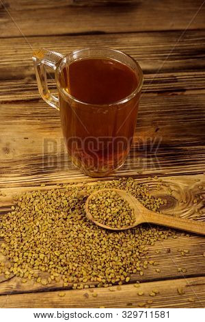 Egyptian Yellow Tea Or Methi Dana Drink And Fenugreek Seeds On Wooden Table