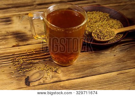 Egyptian Yellow Tea Or Methi Dana Drink And Fenugreek Seeds On Wooden Table