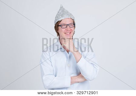 Happy Young Man Doctor With Tinfoil Hat Thinking And Looking Up