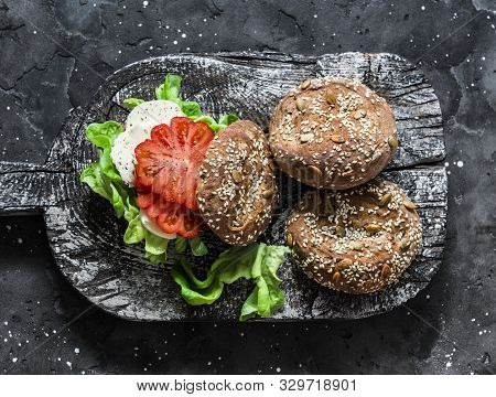 Multigrain Multiseed Fitness Buns And Green Salad Tomato Homemade Cheese Sandwich On Dark Background