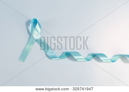 Prostate Cancer Awareness Campaign Concept, Men's Health Concept. Light Blue Ribbon Long Tail On Blu