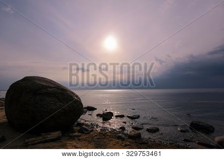Stone Laucu Akmens Located On The Rigas Bay Beach In Latvia During Colorful Sunset In The Summer