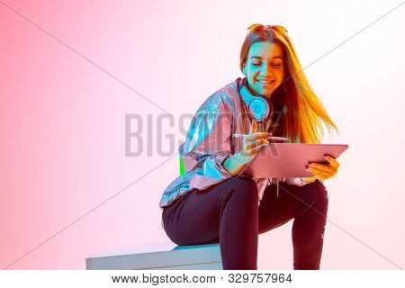 Modern Girl With Laptop, Tablet Computer. Free Creativity. A Young Blogger Makes A Home Office. Colo