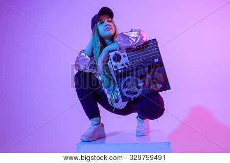 The Girl With The Record Player. Colored Background And Neon Light. Modern Clothes. Music Poster. Re