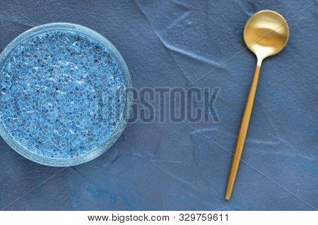 Blue Spirulina Or Butterfly Pea Flower Blue Matcha Powder Chia Seed Pudding Bowl And Golden Spoon. C