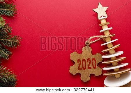 Christmas Red Background With Green And Wood Fir Tree, Snowflakes. View With Copy Space