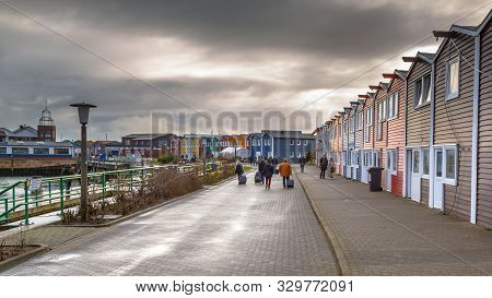 Helgoland, Germany - December 18, 2016: People And Shops In The Harbor Of Helgoland Island On A Clou