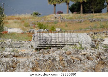 Elements Of Antique Ruins Of Limestone Blocks. The Destroyed Columns. Ruins Of The City Of Hierapoli