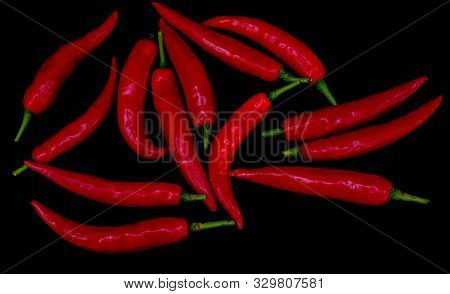 Group Of Red Hot Chili Pepper At Black Background