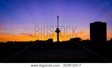 Rotterdam Harbor At Magenta Colored Sunset: View On The Euromast And Delfshaven Area Silhouette.
