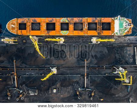 Loading Coal Anthracite On Bulk Vessel Ship In Offshore Cargo Port. Aerial Top View