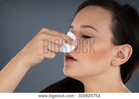 Woman Trying To Stop Blood Bleeding From Nose