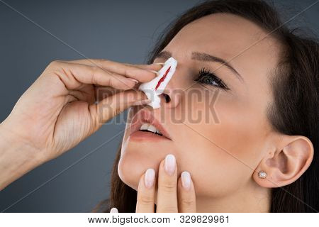 Woman Trying To Stop Blood Bleeding From Nose