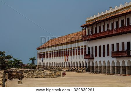 A Piece Of Colonial Edification With Arcs, Windows And Spanish Balconies, In The Front Has A Big Can