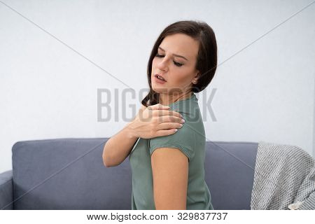 Woman Having Shoulder Pain Sitting At Home