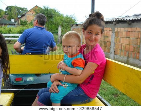 Belgrade, Serbia - August 29, 2019 A Teenage Girl And A Little Boy Ride In A Special Passenger Trail