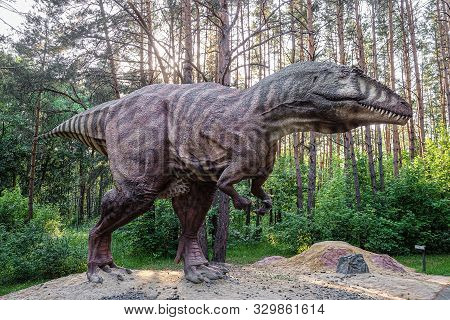 Belgorod, Russia - May 31, 2019: Full-size Gigantosaurus Statue In The Forest Of Belgorod Dinopark. 