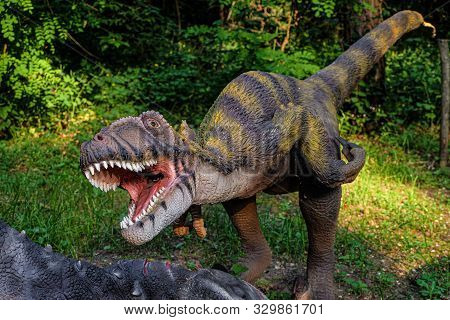Belgorod, Russia - May 31, 2019: Full-size Deinonychus Statue In The Forest Of Belgorod Dinopark. Ca