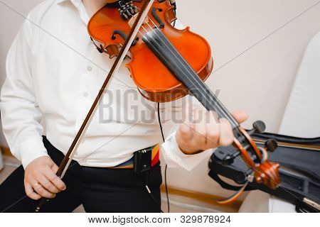 Violin Playing Viola Musician Playing . Man Violinist Classical Musical Instrument  Fiddle .