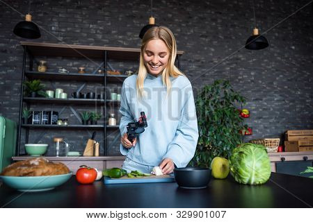 Young Beautiful Blonde Takes On Videos As She Cooks In The Kitchen
