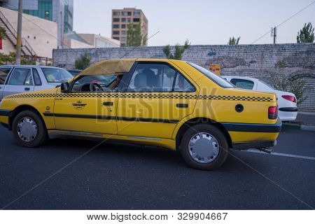 Tabriz, Iran - 11 August 2019 : Taxi, taxi driver and taxi passenger in Tabriz, Iran