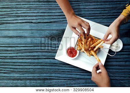 Three Friends Eating French Potato Fries, Serve On Metal Mesh Flying Sieve With Two Dipping Sauce. L