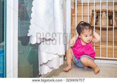 Little adorable girl sitting and playing in living room