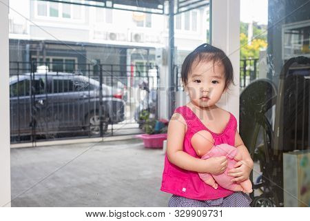 Little Adorable Girl Sitting And Playing In Living Room
