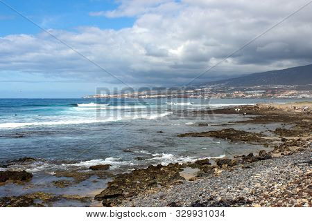 Stony Beach At Playa De Las Americas On Canary Island Tenerife With Blue Water And Blue Sky