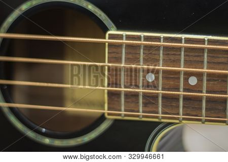 An Acoustic Bass Guitar Exremally Closeup Isolated On The White Background