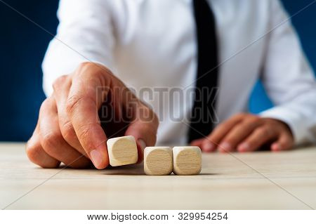 Businessman Placing Three Blank Wooden Dices In A Row