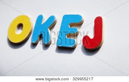 The Word Okej In Wooden Letters On Light Surface