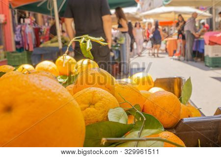 Lamia Greece - July 26 2019; People With Their Purchases Walk Between City Street Market  Produce Ve