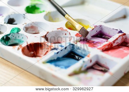 Close Up Palette With Color And Paintbrush