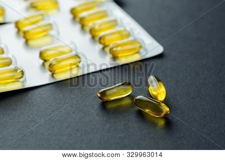 Fishoil Capsules And Blister Pack  On Black Background