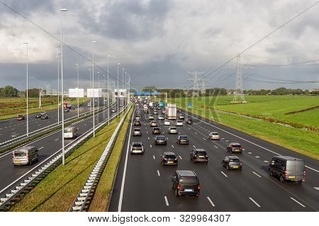 Rush Hour At Dutch Motorway A1 Near Amsterdam With Fourteen Driving Lanes