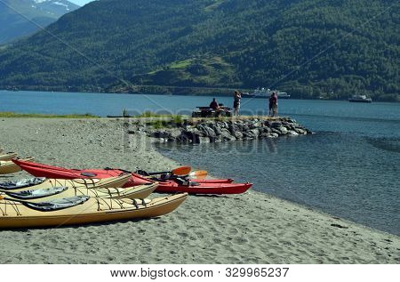 Kayaks on fjord shore in norwegian tourist destination Flam village. Travel, holidays and active lifestyle.Sognefjord.June 17,2018. Flam Norway Scandinavia.