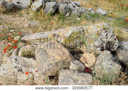 Fragments Of Ancient Buildings, The Ruins Of The Ancient City Of Hierapolis. Stone Blocks With Trace