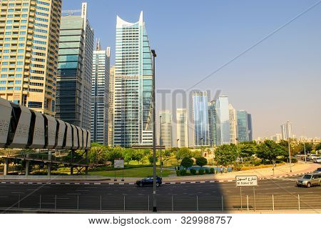 Dubai / Uae - October 15, 2019: Jumeirah Lakes Towers Buildings And Park. Jlt Road With Pedestrian B