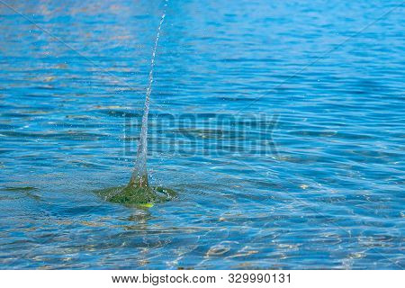Igh Surge Of Water From Falling Into The Sea A Tennis Ball