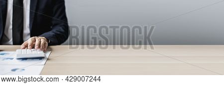 Businessman Sits In A Private Office At His Company And Is Reviewing Company Financial Documents, Se