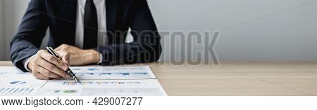 Businessman Sits In A Private Office At His Company And Is Reviewing Company Financial Documents, Se