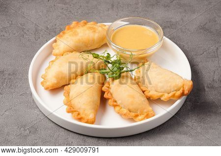 Small Pies Posikunchiki On A White Plate
