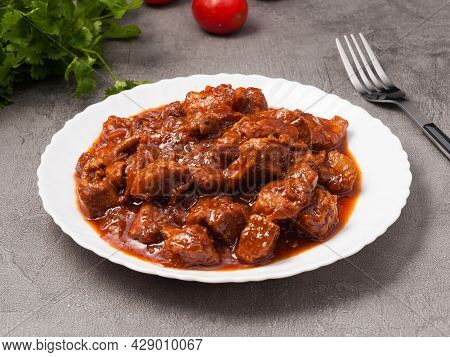 Pork Goulash With Tomato Paste On A White Plate